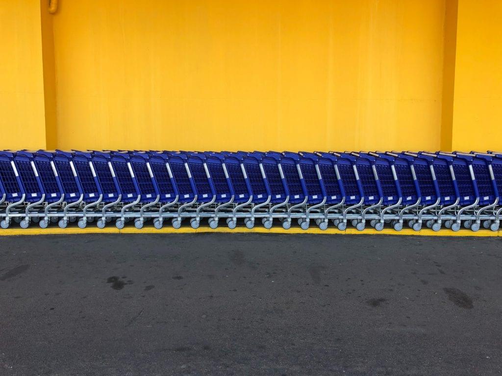 Walmart blue carts against a yellow wall